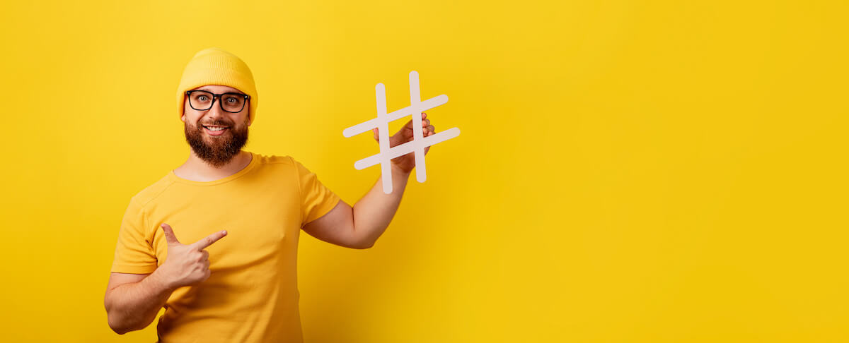 How to get on the FYP: person holding a hashtag