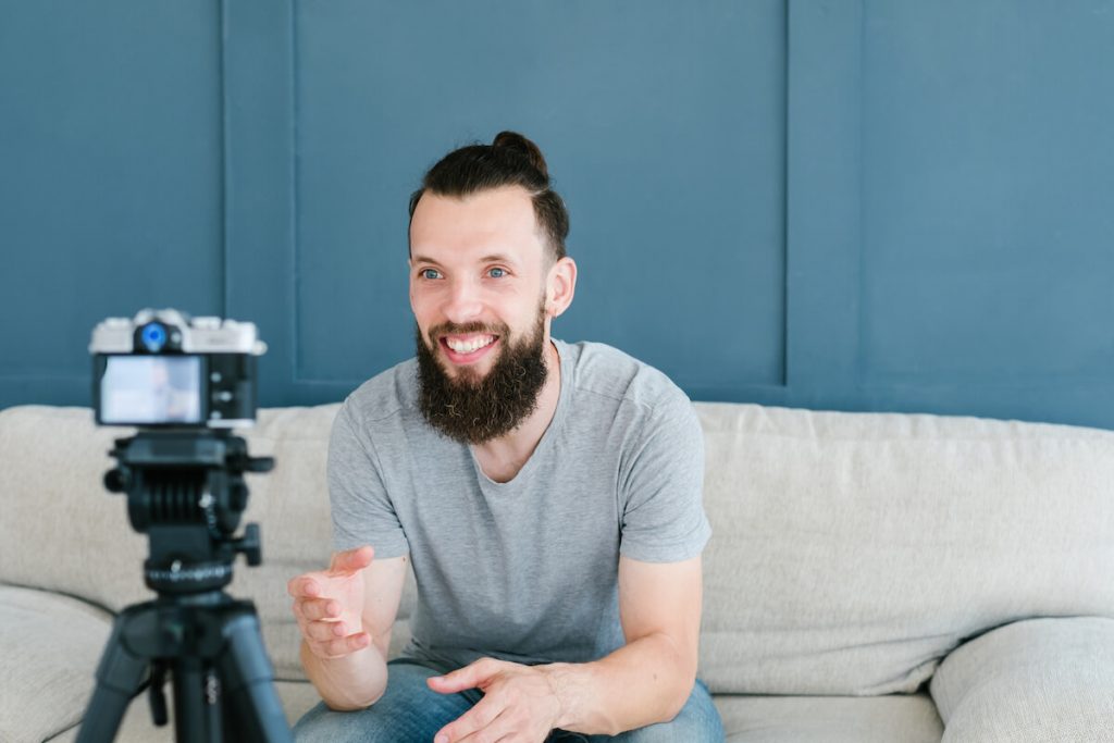 Benefits of influencer marketing: Man films himself sitting on couch