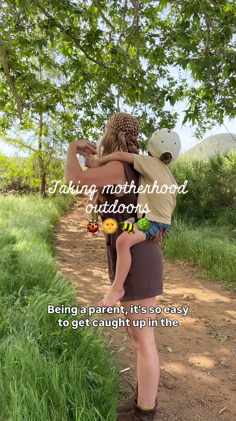 A frame from Sasha Dubè’s Murphy’s Naturals creator video, showing a parent carrying a child along a wooded trail.