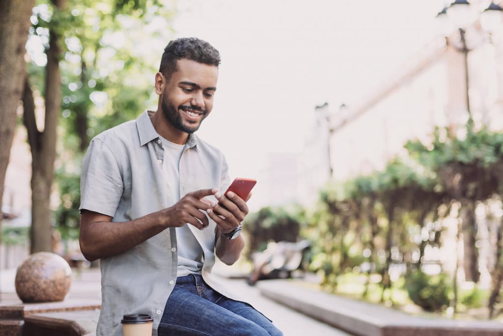 Instagram Impressions: man happily using his smartphone